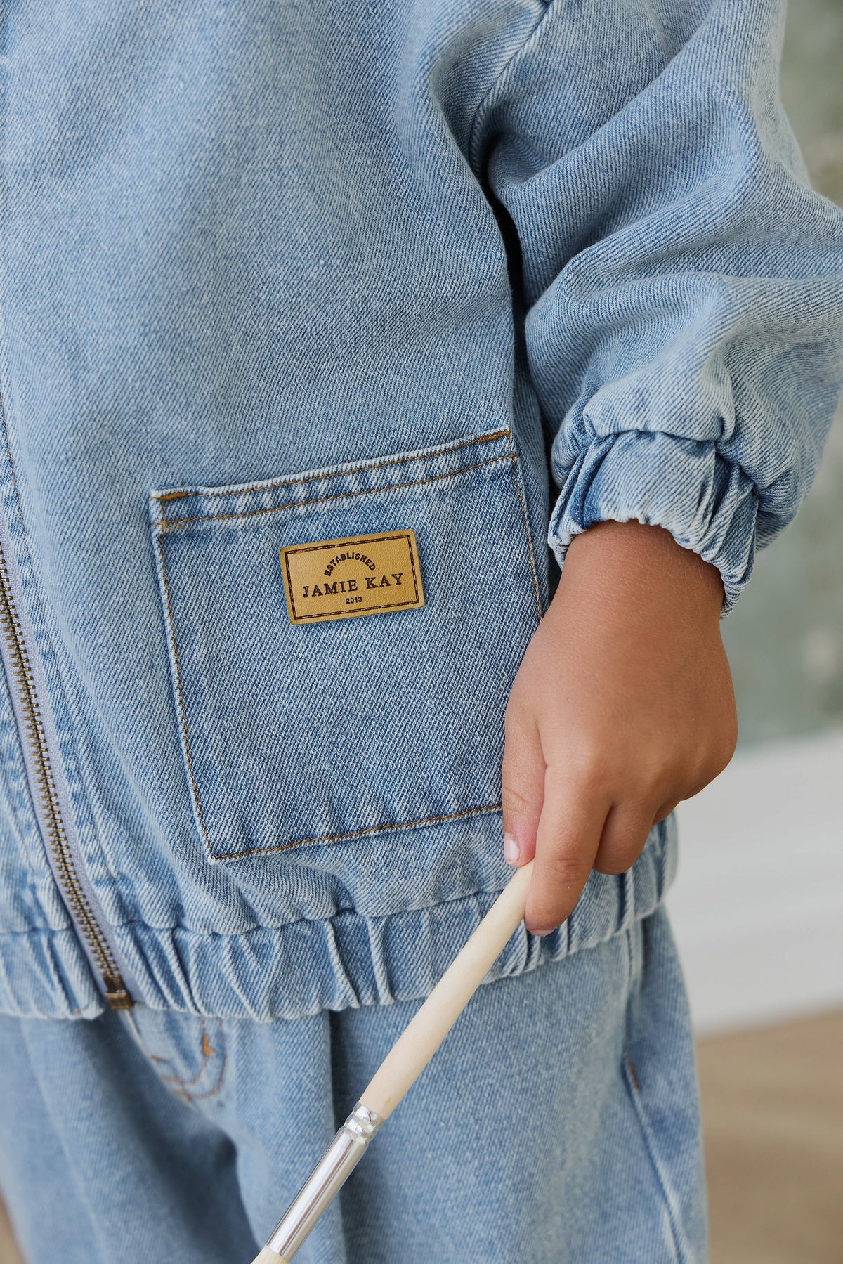 Veste décontractée en jean de coton bleu clair uni pour enfant, avec fermeture éclair, col montant et poches plaquées, idéale pour les intersaisons