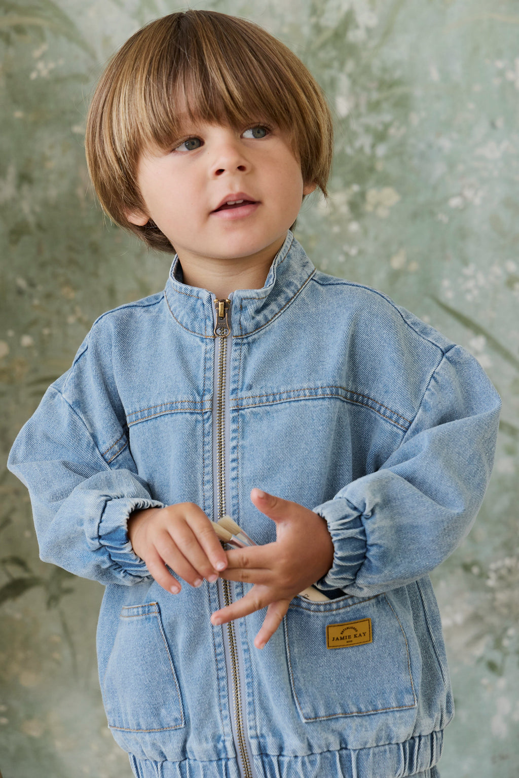 Veste décontractée en jean de coton bleu clair uni pour enfant, avec fermeture éclair, col montant et poches plaquées, idéale pour les intersaisons