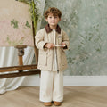 Veste matelassée en losanges 100 % coton unie de couleur grès neutre avec col en velours côtelé et fermeture éclair à l'avant pour enfants, idéale pour les intersaisons.
