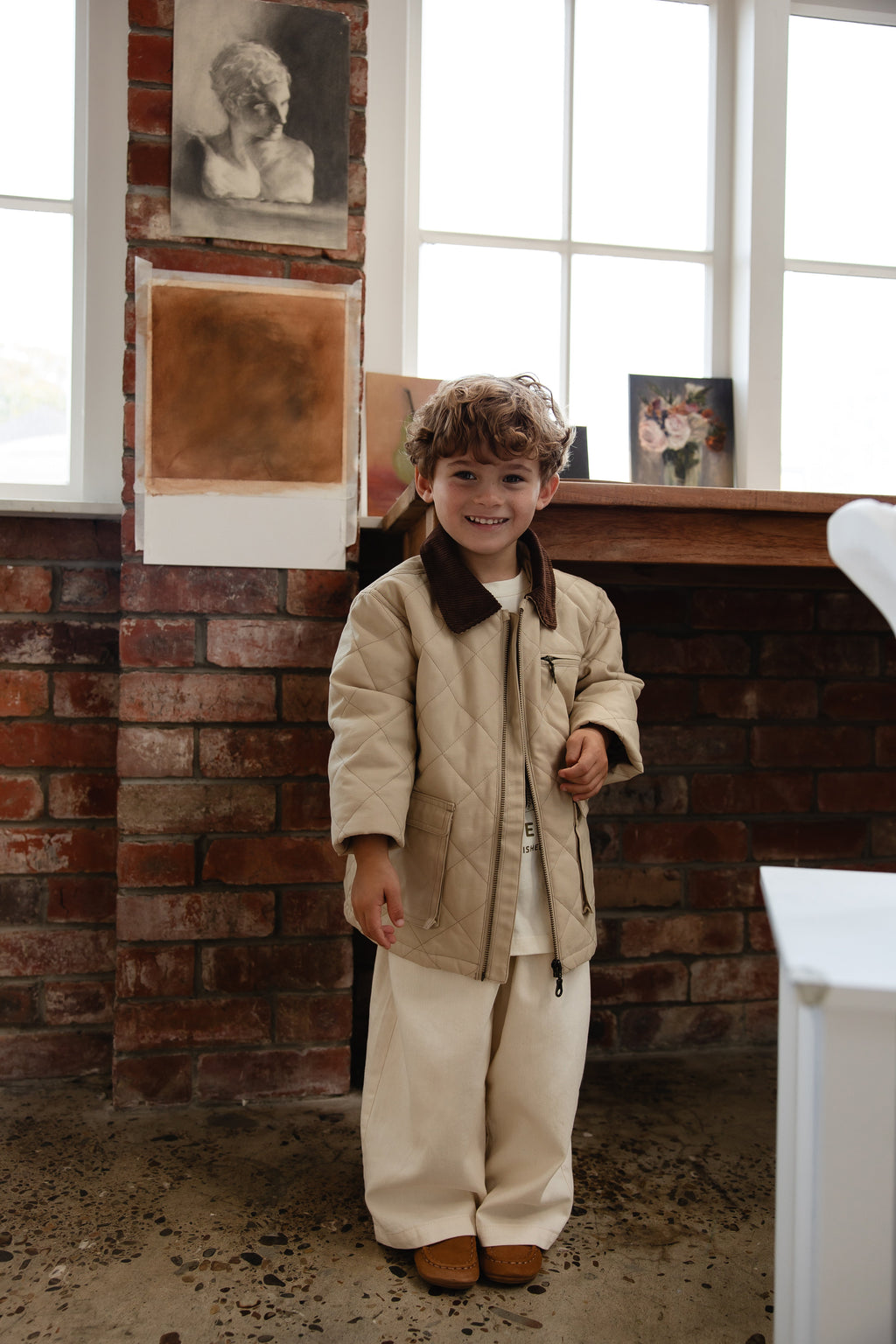 Veste matelassée en losanges 100 % coton unie de couleur grès neutre avec col en velours côtelé et fermeture éclair à l'avant pour enfants, idéale pour les intersaisons.